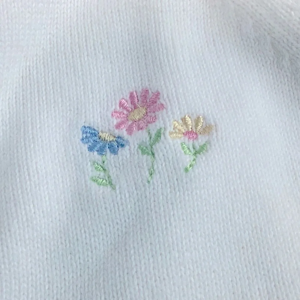 Carter’s white sweater with pink trim on neck, sleeve and hem. 12 months